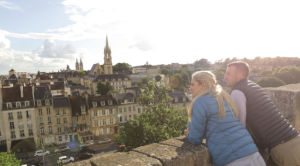 An image of a couple looking over the city of Caen